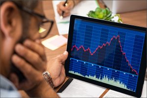 Man reviewing a graph on a computer screen